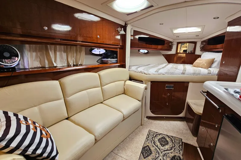 Slide: The Image of Luxurious interior of 2013 Four Winns V335 yacht with beige seating and cozy bed. - 11