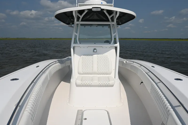 Slide: The Image of 2015 Cape Horn 31T boat on water, featuring sleek white seating and console. - 15
