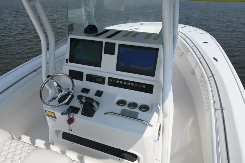 Slide: The Image of Cockpit of 2015 Cape Horn 31T boat with dual navigation screens and steering wheel. - 21