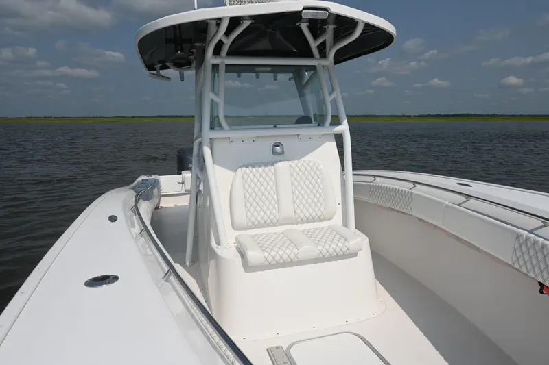 Slide: The Image of 2015 Cape Horn 31T boat with white seating, on calm water under a blue sky. - 16