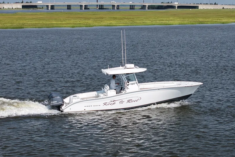 Slide: The Image of 2015 Cape Horn 31T boat cruising on water near a bridge. - 8