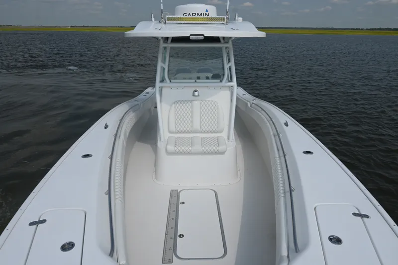 Slide: The Image of 2015 Cape Horn 31T boat on water, featuring spacious deck and seating. - 12