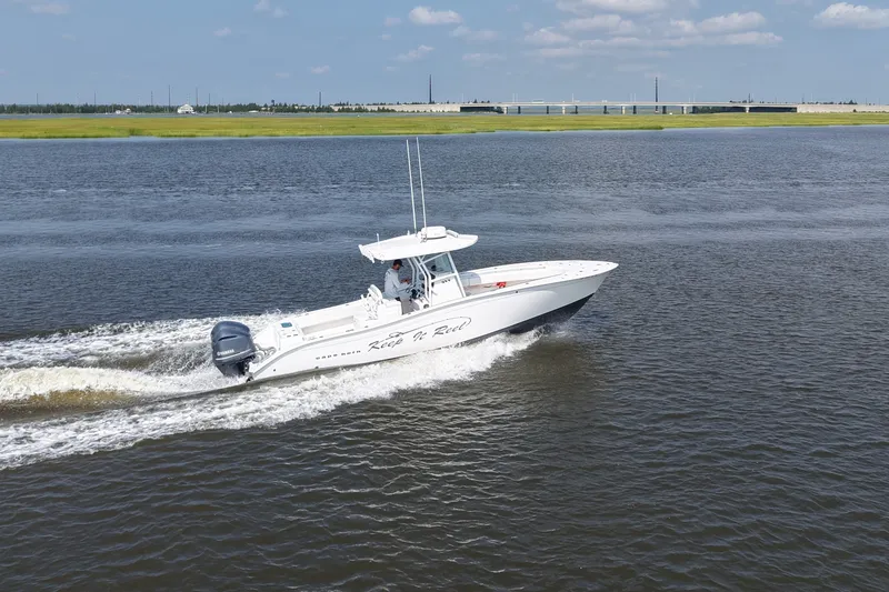 Slide: The Image of 2015 Cape Horn 31T boat cruising on a calm river under a blue sky. - 10