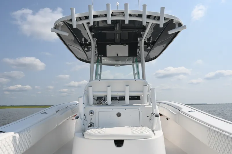Slide: The Image of 2015 Cape Horn 31T boat with T-top, rod holders, and spacious deck on open water. - 26