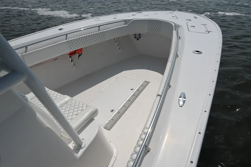 Slide: The Image of 2015 Cape Horn 31T boat interior with cushioned seating and open deck on water. - 18