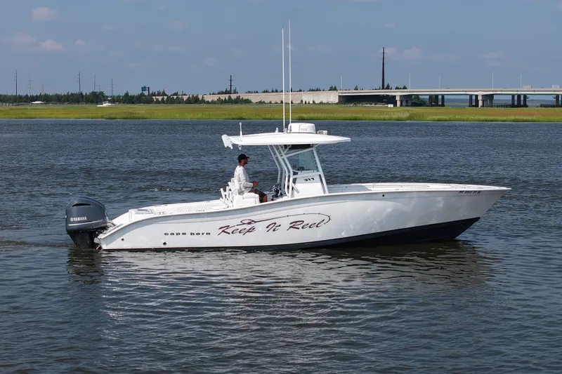 Slide: The Image of 2015 Cape Horn 31T boat on water, featuring Yamaha engine, with "Keep It Reel" text. - 4