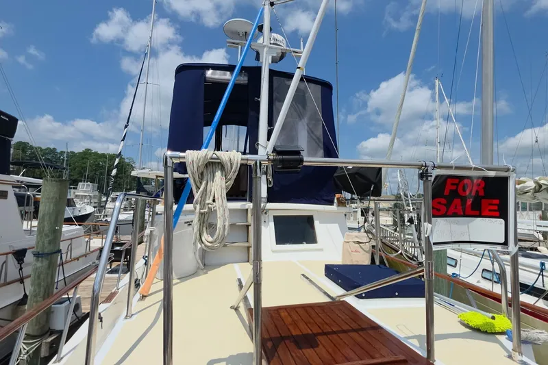 Slide: The Image of 1983 Monk 36 yacht for sale at marina, clear sky background. - 5