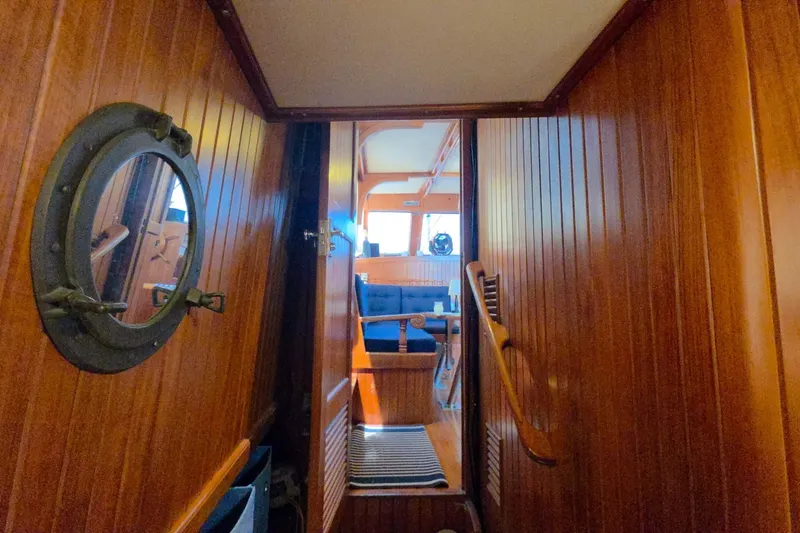 Slide: The Image of Interior of 1983 Monk 36 boat with wooden paneling and porthole window. - 23