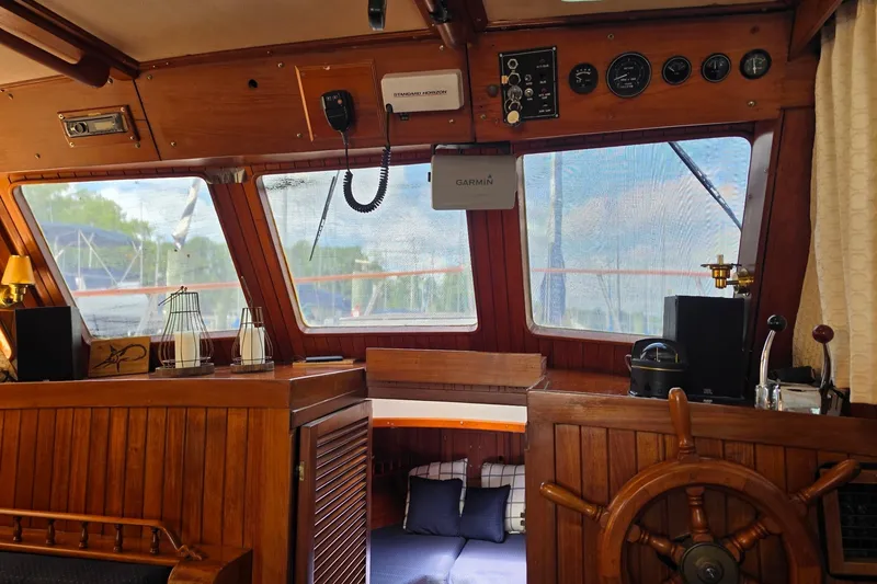Slide: The Image of Interior of a 1983 Monk 36 boat with wooden helm and nautical instruments. - 11