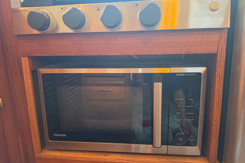 Slide: The Image of Built-in Toshiba microwave with Greystone controls in a 1983 Monk 36 model kitchen. - 25