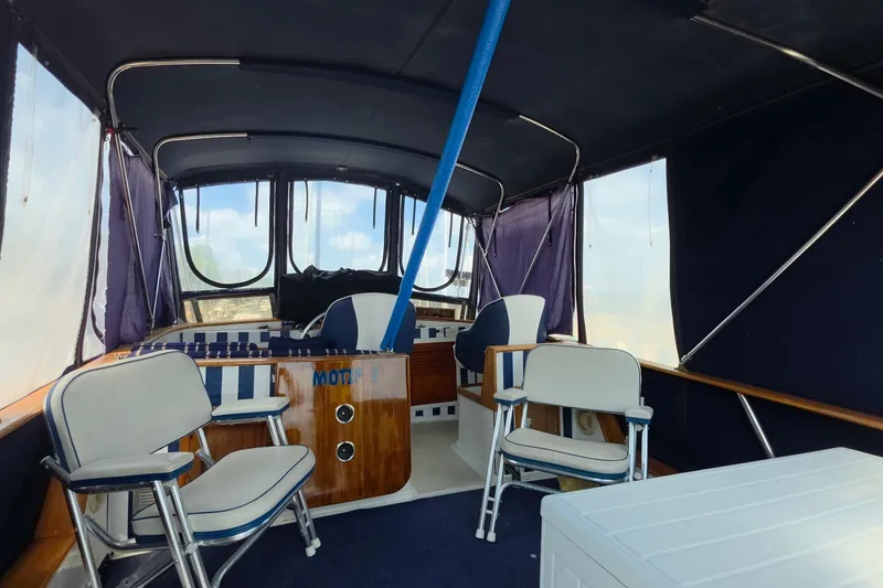 Slide: The Image of Interior of a 1983 Monk 36 boat with seating and helm station. - 7
