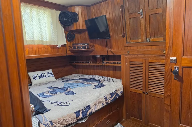 Slide: The Image of Cozy cabin interior of 1983 Monk 36 boat with wood paneling and nautical decor. - 20
