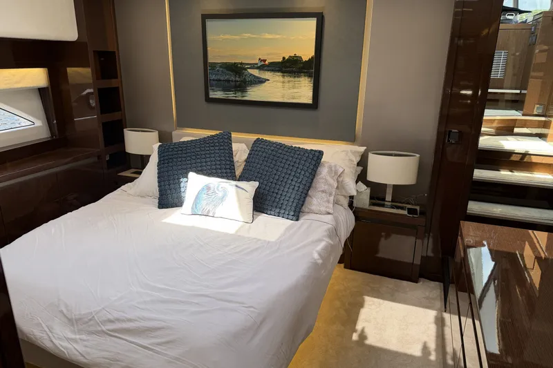 Slide: The Image of Luxurious bedroom interior of 2023 Prestige 690 yacht with elegant decor and artwork. - 25