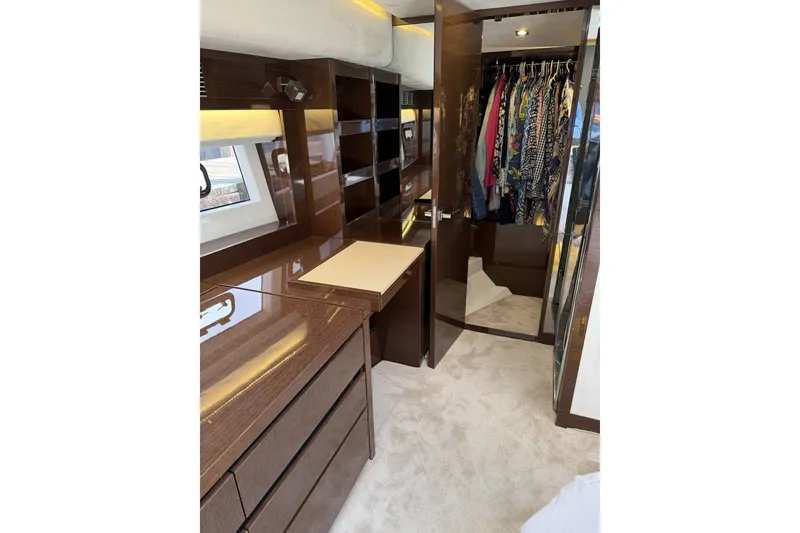 Slide: The Image of Luxurious interior of 2023 Prestige 690 yacht with elegant wood finishes and spacious closet. - 27