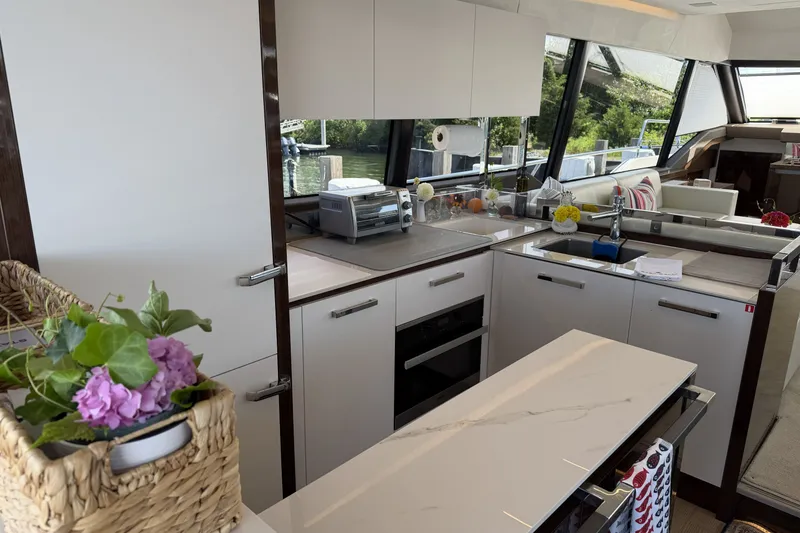 Slide: The Image of Luxurious kitchen interior of 2023 Prestige 690 yacht with modern appliances and elegant design. - 17