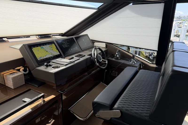 Slide: The Image of Luxurious 2023 Prestige 690 yacht helm with advanced navigation displays and plush seating. - 23