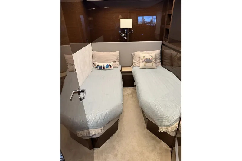 Slide: The Image of Luxurious twin beds in 2023 Prestige 690 yacht cabin, featuring elegant decor and soft lighting. - 34