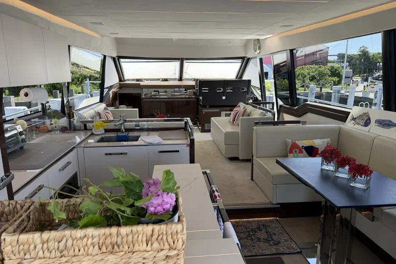 Slide: The Image of Luxurious interior of 2023 Prestige 690 yacht with modern kitchen and elegant seating area. - 16