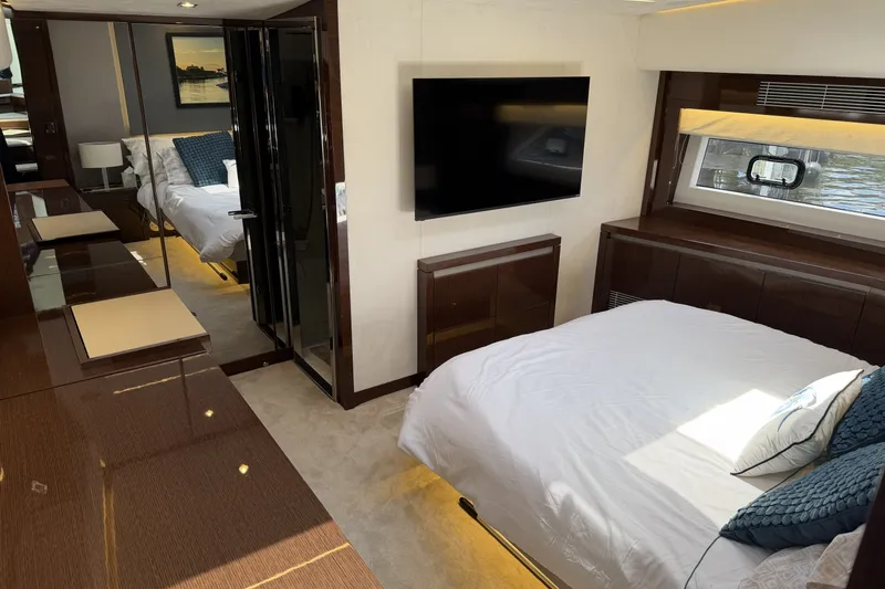 Slide: The Image of Luxurious interior of 2023 Prestige 690 yacht with modern bedroom and elegant furnishings. - 24