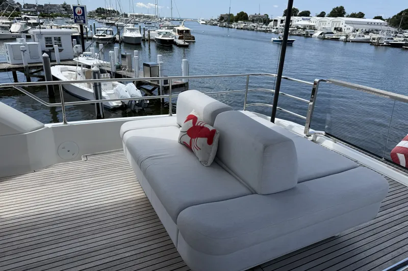 Slide: The Image of Luxury yacht Prestige 690 deck with plush seating, overlooking marina. - 14