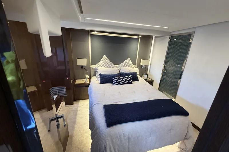 Slide: The Image of Luxurious bedroom interior of 2023 Prestige 690 yacht with modern decor and plush bedding. - 31