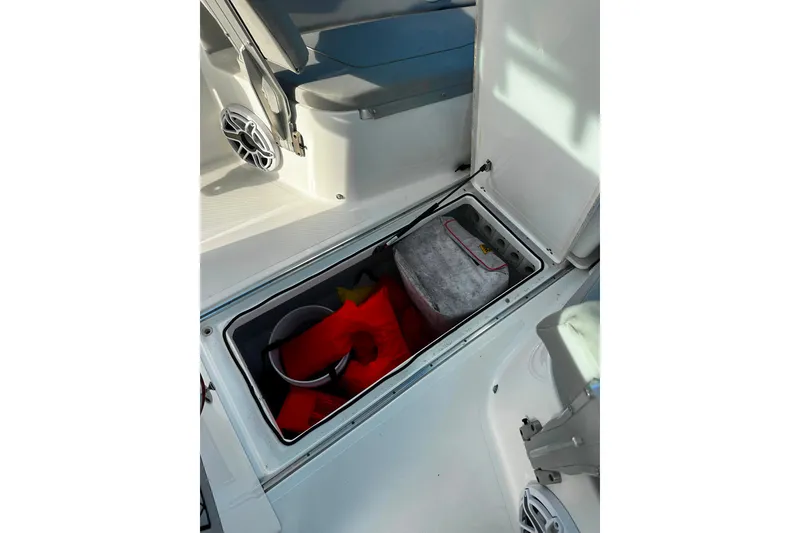 Slide: The Image of Storage compartment on 2021 Wellcraft 262 Fisherman boat with life jackets and equipment. - 29