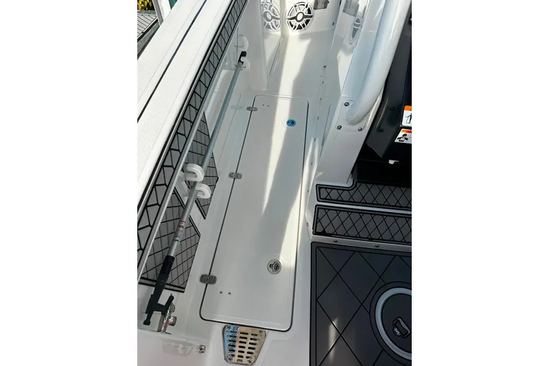 Slide: The Image of 2021 Wellcraft 262 Fisherman boat deck with storage compartment and rod holder. - 20