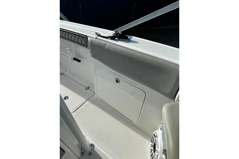 Slide: The Image of 2021 Wellcraft 262 Fisherman boat interior detail with storage compartment and speaker. - 15