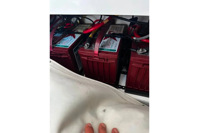 Slide: The Image of Batteries inside a 2021 Wellcraft 262 Fisherman boat, showcasing electrical components. - 21
