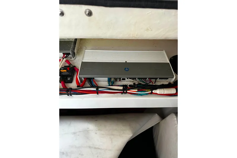 Slide: The Image of Electrical components inside a 2021 Wellcraft 262 Fisherman boat, featuring organized wiring and equipment. - 28