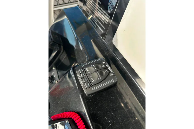 Slide: The Image of Control panel on 2021 Wellcraft 262 Fisherman boat dashboard with red safety cord. - 22