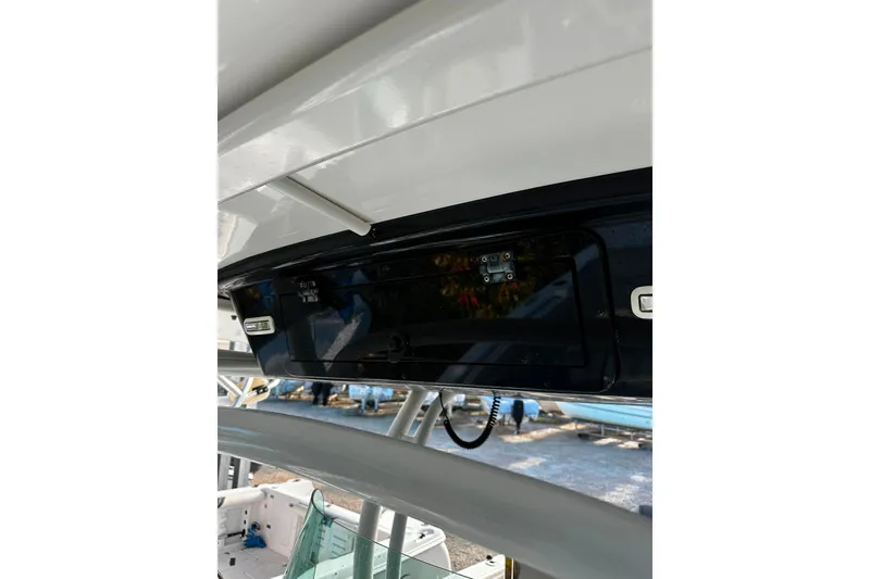 Slide: The Image of 2021 Wellcraft 262 Fisherman boat console with electronic controls and storage compartment. - 26