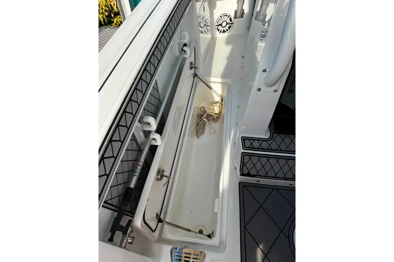 Slide: The Image of 2021 Wellcraft 262 Fisherman boat storage compartment with rope and equipment. - 27