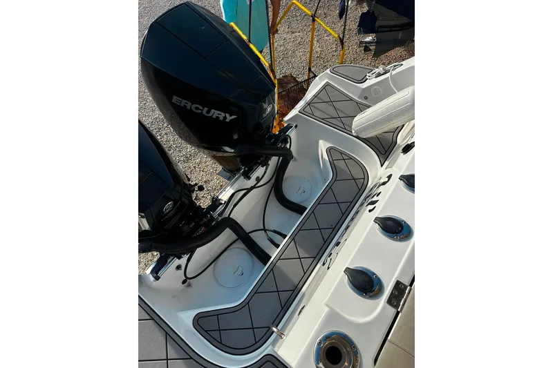 Slide: The Image of 2021 Wellcraft 262 Fisherman boat with dual Mercury outboard engines, featuring a sleek deck design. - 25