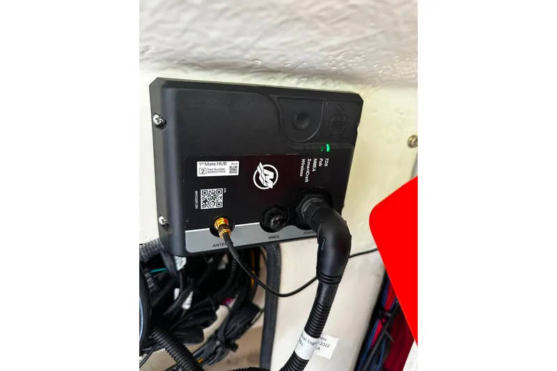 Slide: The Image of Electronic device installation on 2021 Wellcraft 262 Fisherman boat, featuring wiring and connectors. - 33