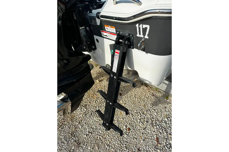 Slide: The Image of 2021 Wellcraft 262 Fisherman boat ladder on gravel surface. - 19