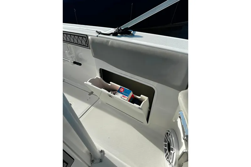 Slide: The Image of 2021 Wellcraft 262 Fisherman boat interior storage compartment with speaker and accessories. - 31