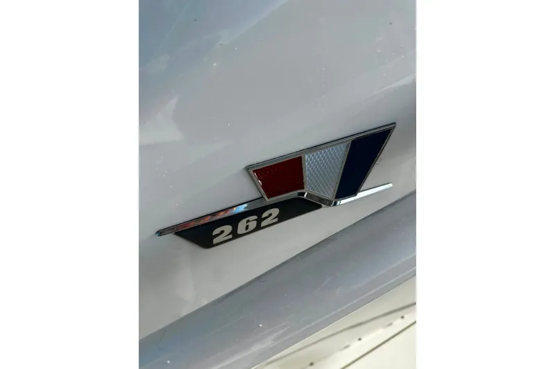 Slide: The Image of 2021 Wellcraft 262 Fisherman emblem on white surface, featuring red, white, and blue design. - 18