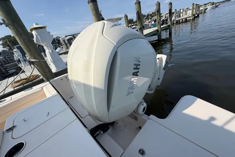 Slide: The Image of 2025 Grady-White Freedom 235 boat with Yamaha outboard engine at a marina dock. - 38