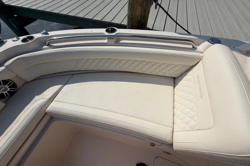 Slide: The Image of Luxurious seating on 2025 Grady-White Freedom 235 boat, featuring elegant white upholstery. - 13