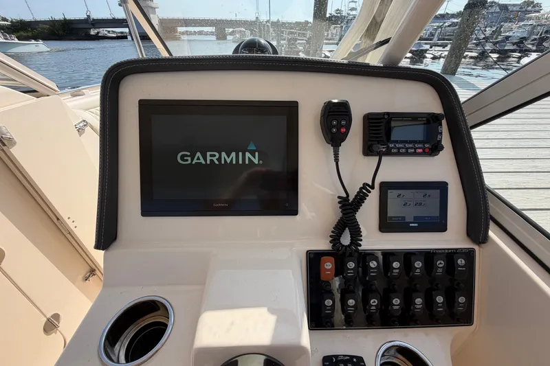 Slide: The Image of Dashboard of a 2025 Grady-White Freedom 235 boat with Garmin navigation system. - 18