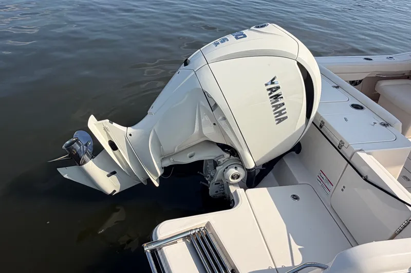 Slide: The Image of 2025 Grady-White Freedom 235 boat with Yamaha outboard motor on calm water. - 35