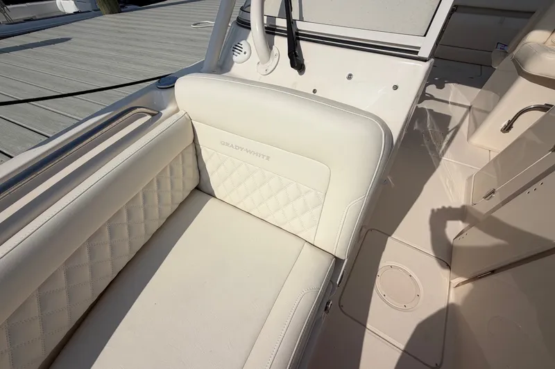 Slide: The Image of 2025 Grady-White Freedom 235 boat interior with white cushioned seating. - 15