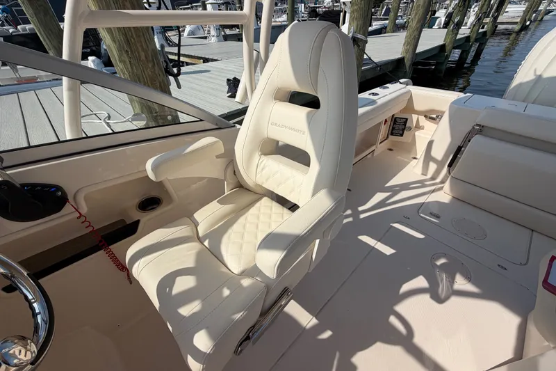 Slide: The Image of Luxury seating on 2025 Grady-White Freedom 235 boat, docked at marina. - 25