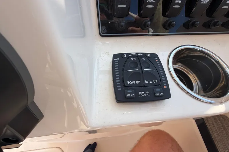 Slide: The Image of Control panel of 2025 Grady-White Freedom 235 boat with trim tab controls. - 22