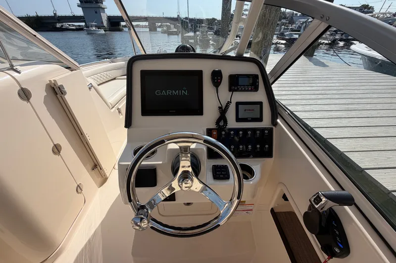 Slide: The Image of 2025 Grady-White Freedom 235 boat helm with Garmin navigation system at marina. - 17