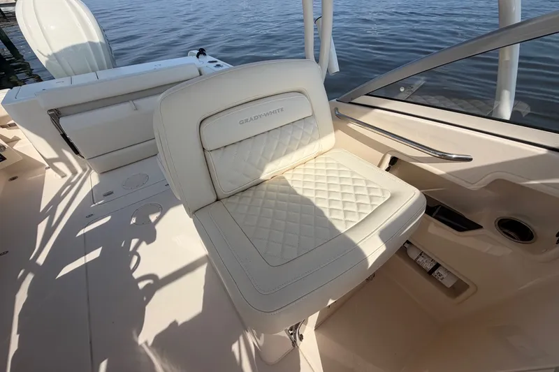 Slide: The Image of Luxury seating on 2025 Grady-White Freedom 235 boat, featuring quilted upholstery and sleek design. - 26
