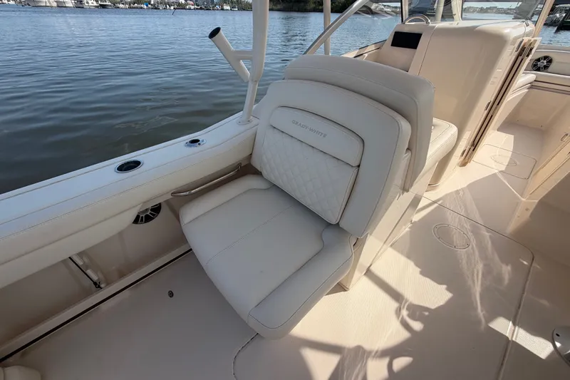 Slide: The Image of 2025 Grady-White Freedom 235 boat interior with luxurious seating by the water. - 27
