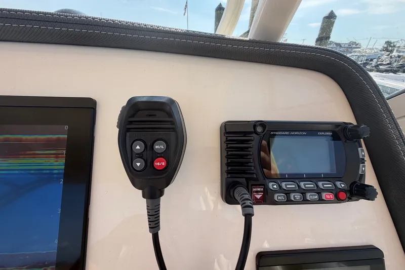 Slide: The Image of Control panel of 2025 Grady-White Freedom 235 boat with radio and display. - 21