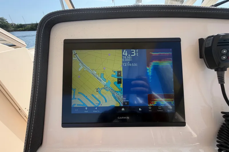 Slide: The Image of Garmin navigation display on 2025 Grady-White Freedom 235 boat, showing map and sonar data. - 19